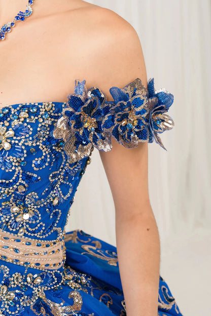 Side half close-up view of Royal quinceañera ball gown with off shoulder bodice, gold embroidery, floral appliqués, voluminous tulle skirt, corset back, and oversized bow