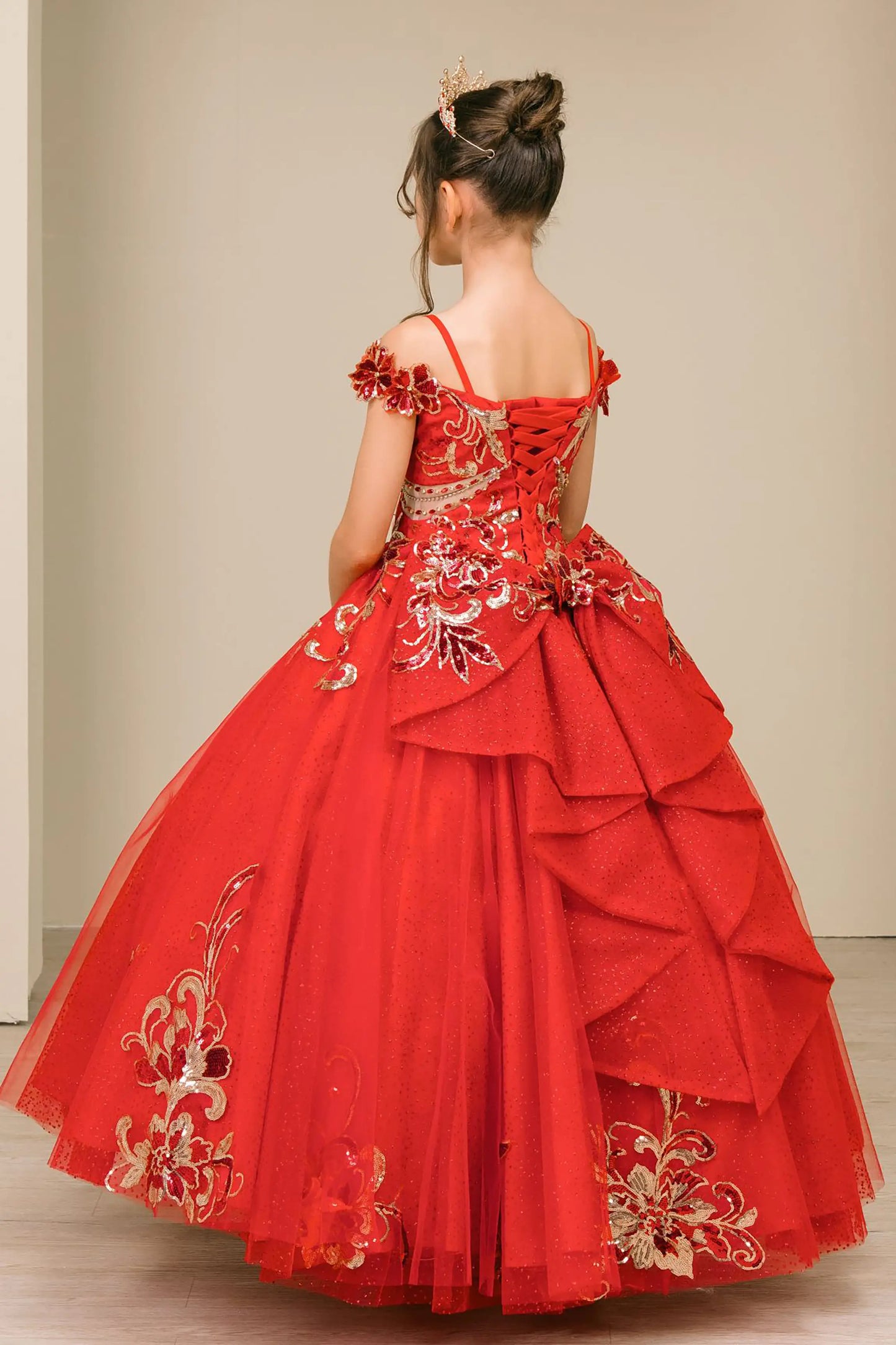 Back full-length view of Red mini quince ball gown with off shoulder floral embroidered bodice, glitter tulle skirt, lace up back, and layered bow