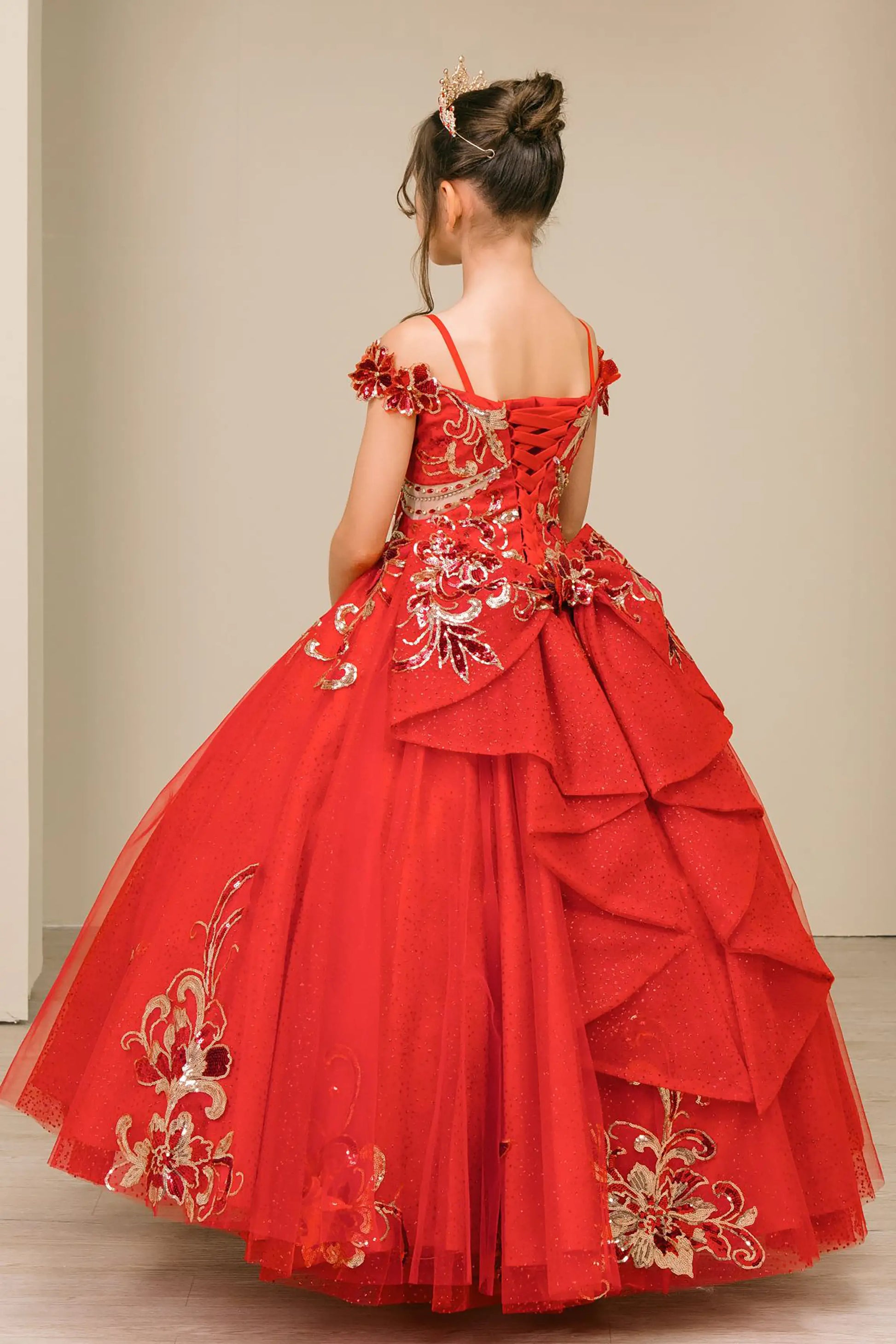 Back full-length view of Red mini quince ball gown with off shoulder floral embroidered bodice, glitter tulle skirt, lace up back, and layered bow