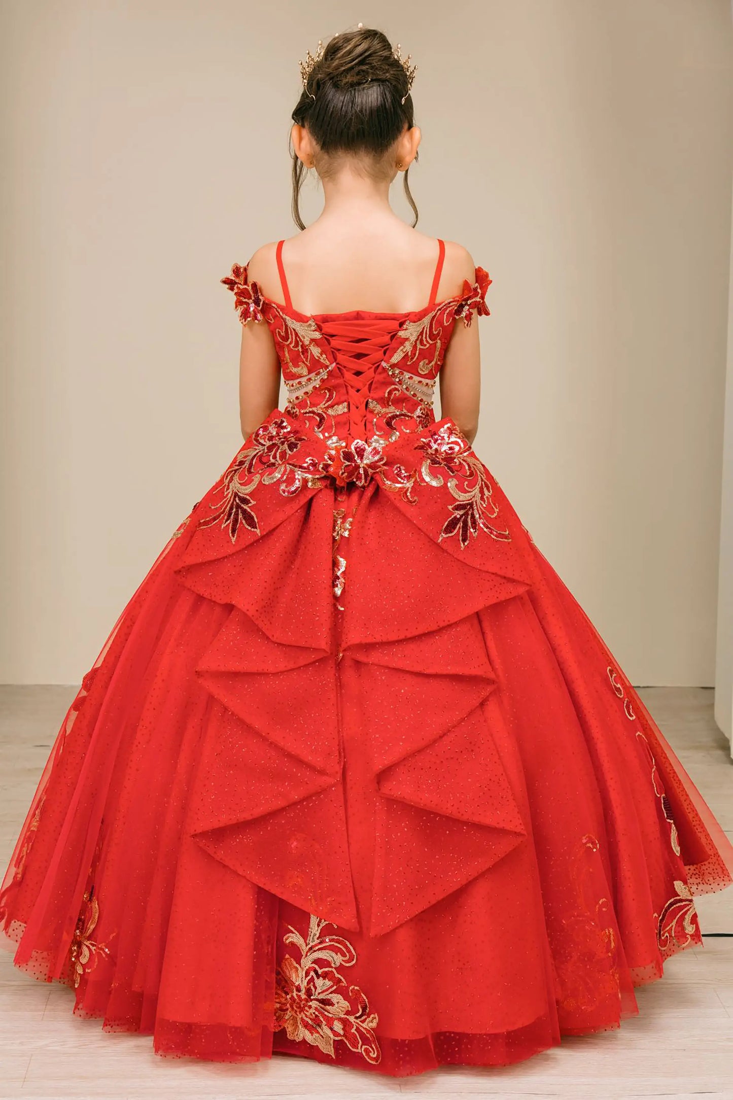 Back full-length view of Red mini quince ball gown with off shoulder floral embroidered bodice, glitter tulle skirt, lace up back, and layered bow