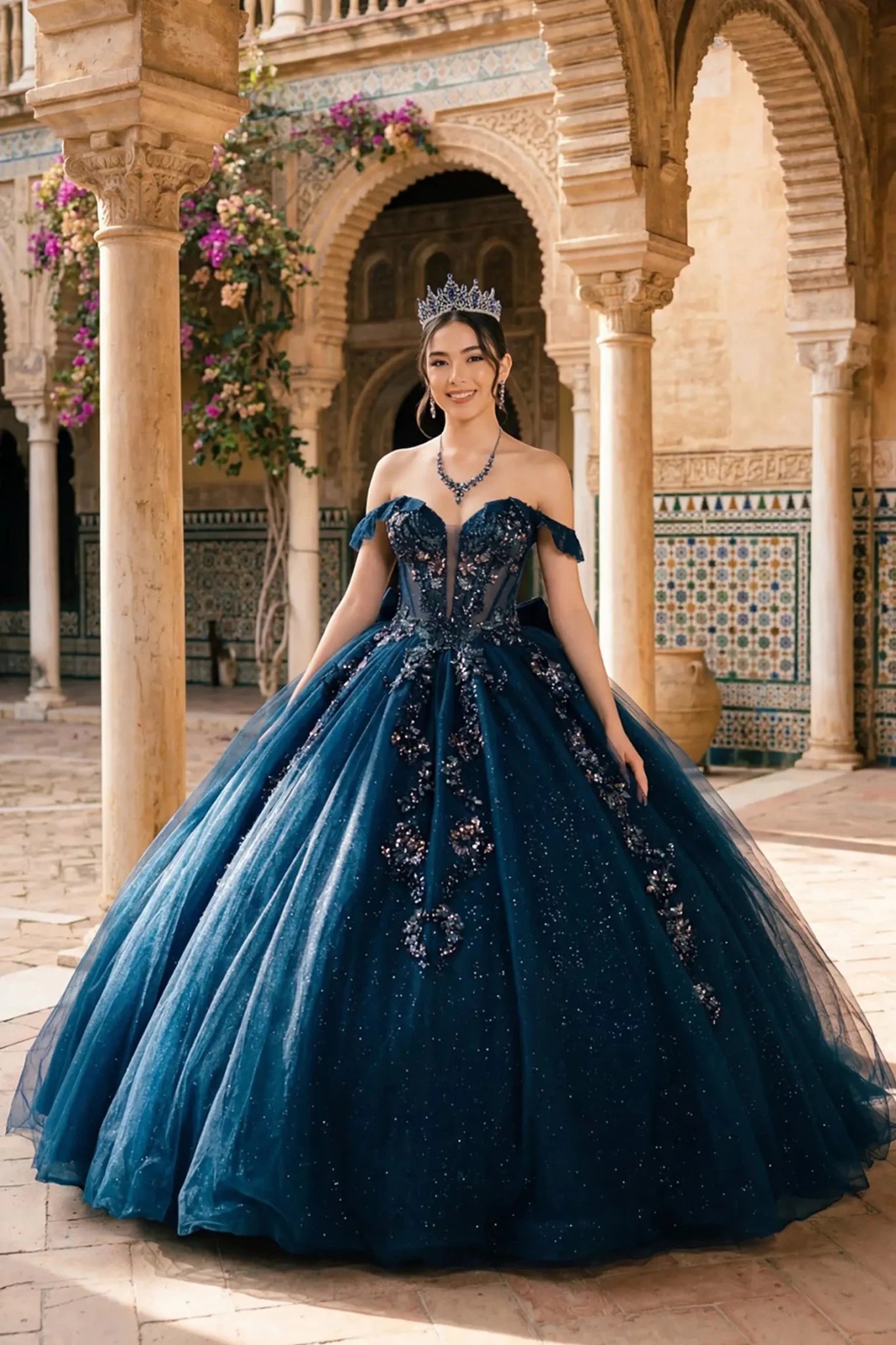 Woman wearing navy quinceañera royal dress with embroidered beaded corset bodice, shimmering textured skirt, cathedral train, detachable cape, and gloves