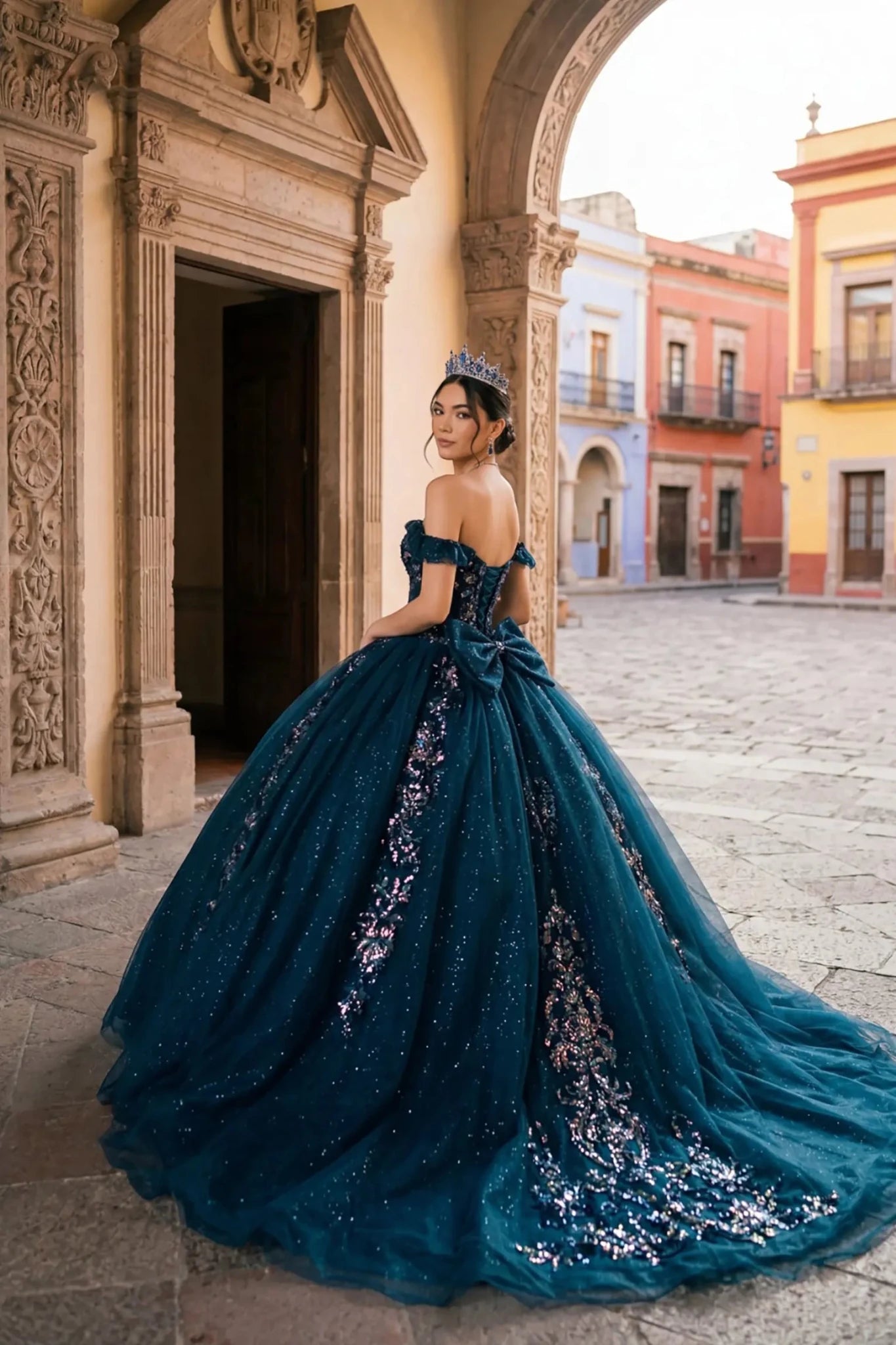 Woman wearing navy quinceañera royal dress side-facing with embroidered beaded corset bodice and shimmering textured skirt