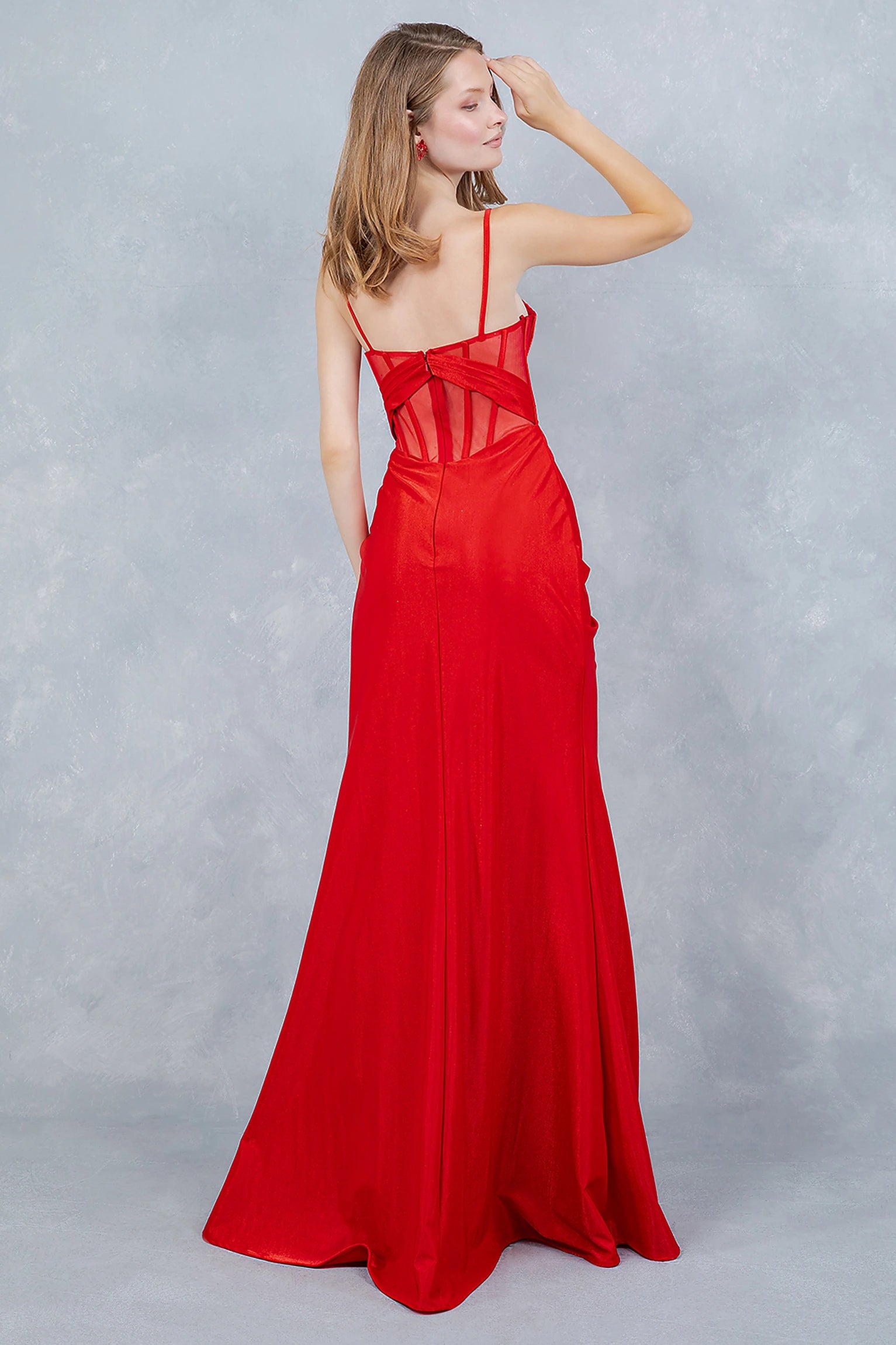Red prom dress designed with open back and zipper closure
