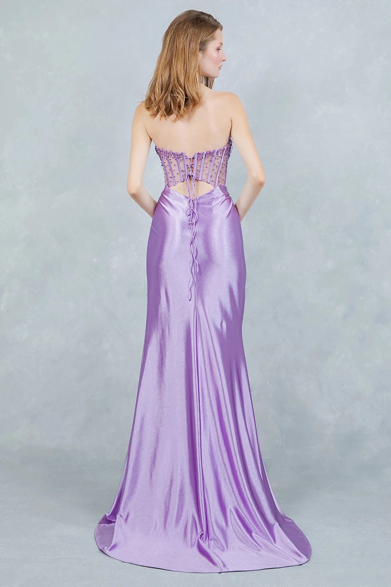 Lilac Evening dress showcasing lace-up corset back with sleek sweeping train trailing behind