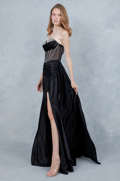 Textured details appear across black evening gown styled with high side slit and ruching at waist for flattering fit.