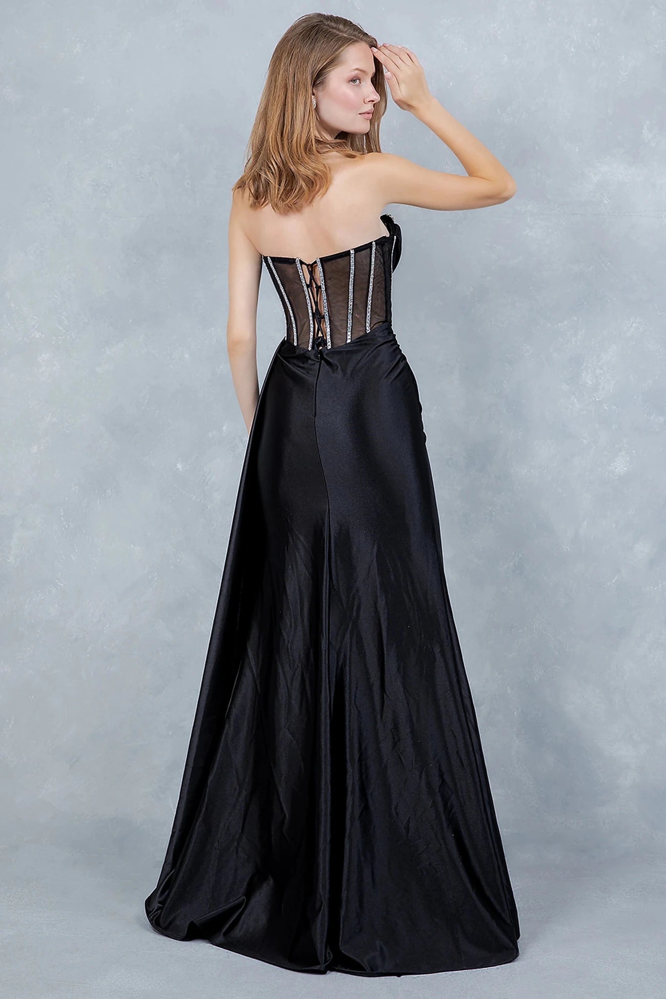 Black evening gown showcasing lace-up corset back with delicate crisscrossing ties
