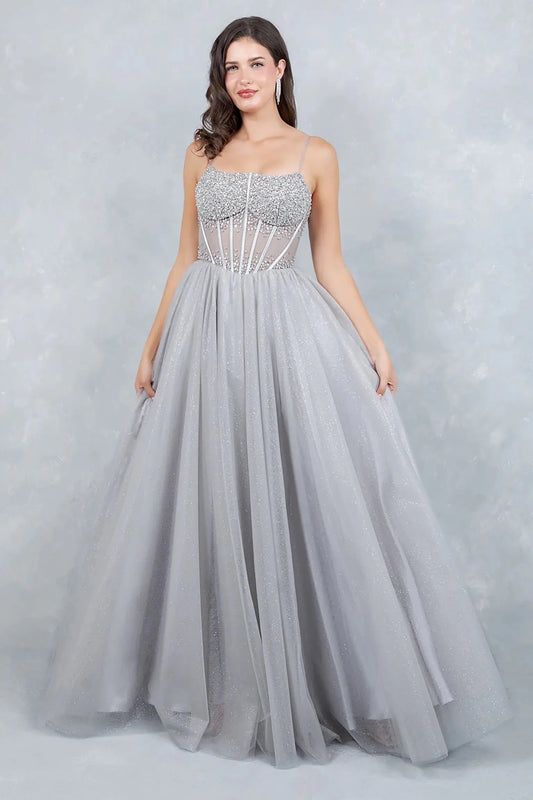 Full front view of a women wearing silver crystal corset prom dress with delicate straps and voluminous shimmering tulle skirt.