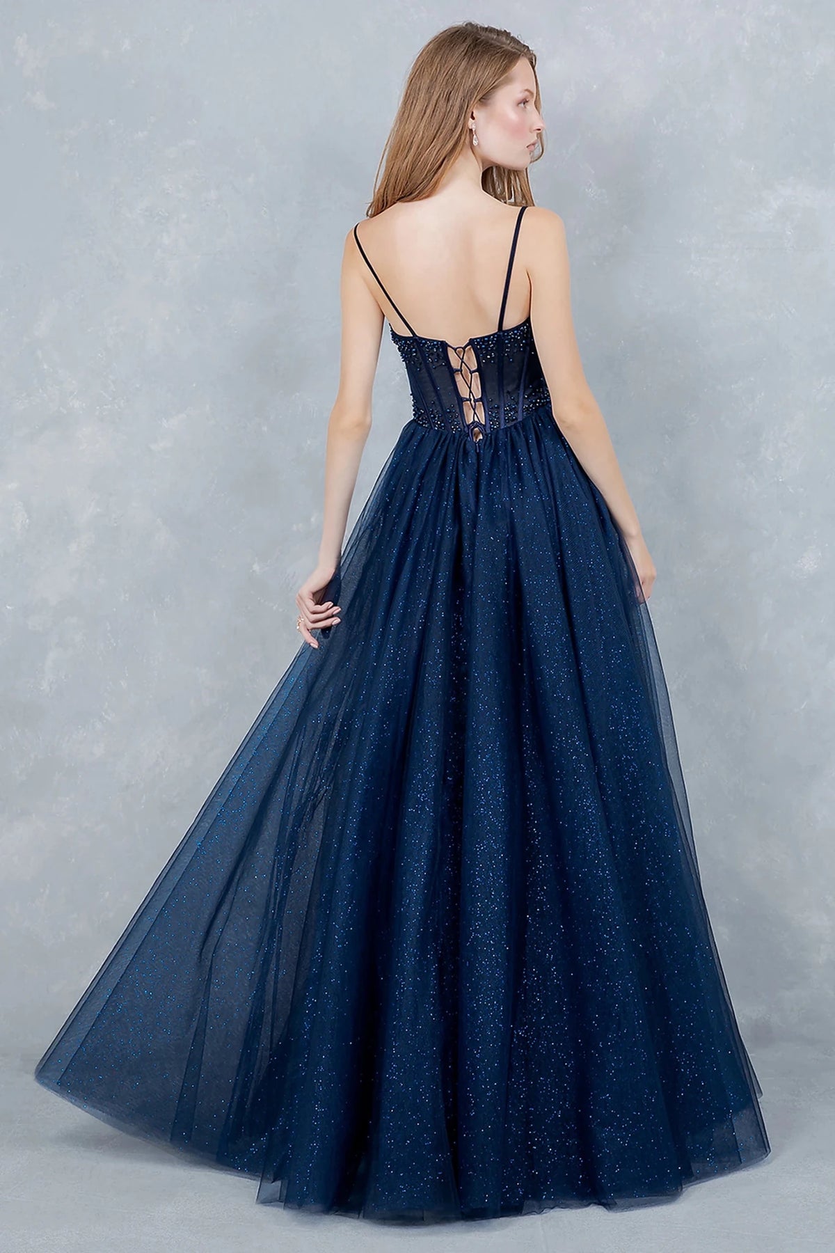 Navy evening dress styled with thin straps and lace-up back for adjustable fit