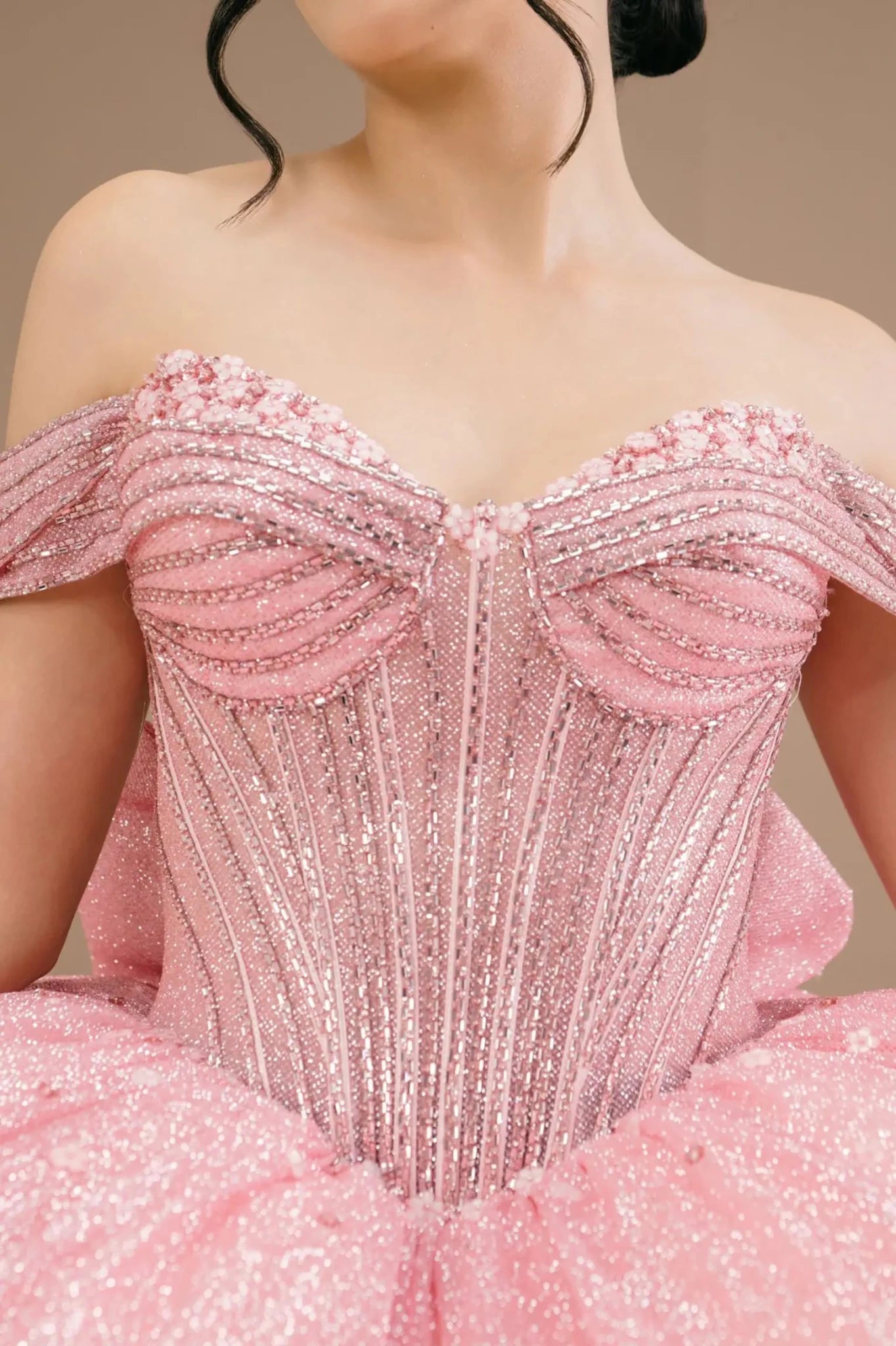Rose gold off-shoulder sweetheart ball gown with beaded corset bodice, glitter detailing, and elegant neckline