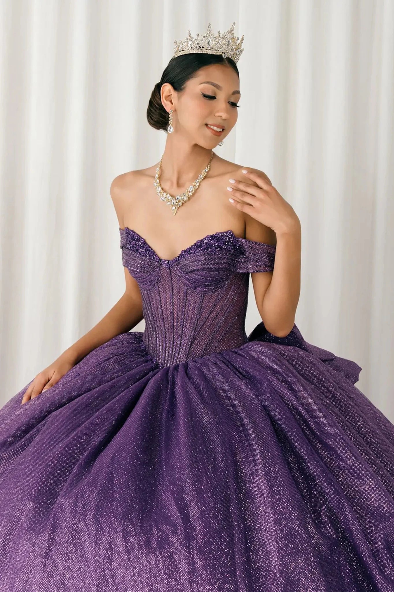 Woman standing front-facing in elegant purple ball gown with beaded corset bodice and voluminous glitter tulle skirt

