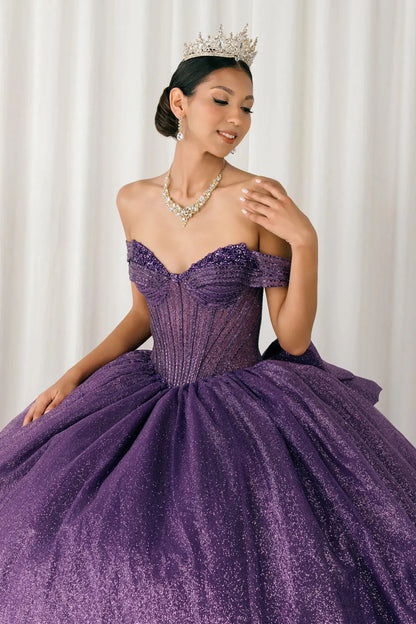 Woman standing front-facing in elegant purple ball gown with beaded corset bodice and voluminous glitter tulle skirt

