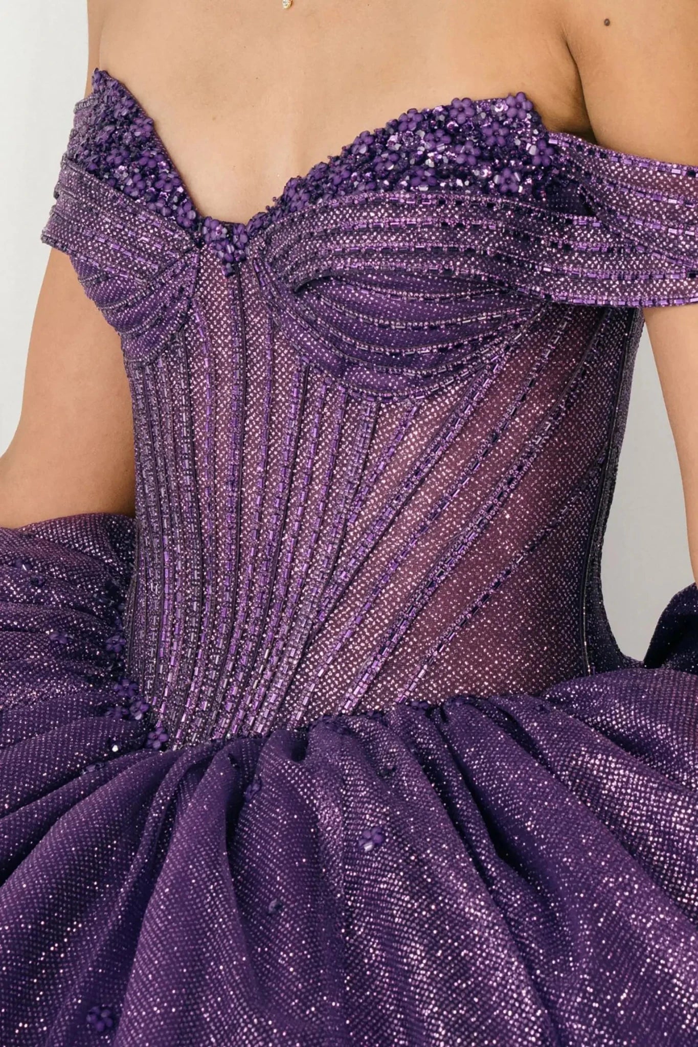 Close-up front-facing view of purple ball gown with intricately beaded corset bodice and sweetheart neckline


