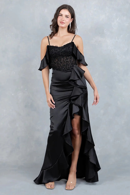 A full-length front view of a woman wearing a black formal dress designed with a fitted silhouette and flowing train.