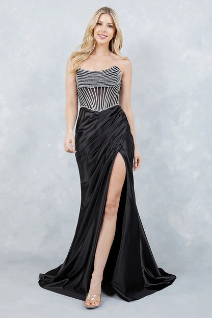 Full front view of a women wearing black satin prom dress with rhinestone corset bodice and high slit.
