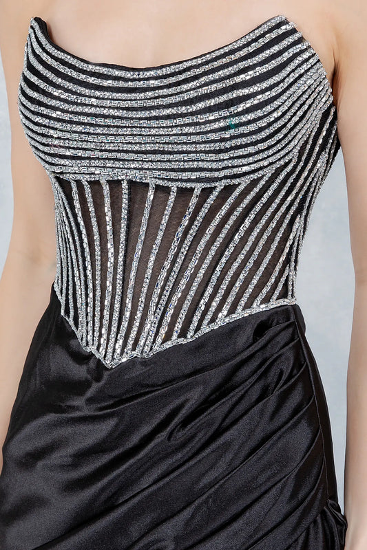 Black evening dress featuring geometric beaded pattern contouring figure with sparkle