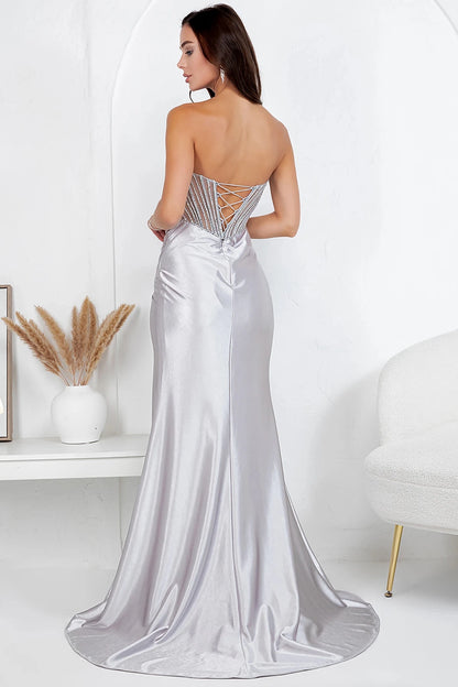 Rear view reveals silver evening dress showcasing gathered pleating detail at hip with lace-up corset back.