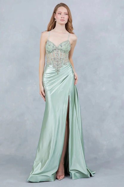 A full-length view of a woman wearing sage formal dress with a lace-up corset and train.