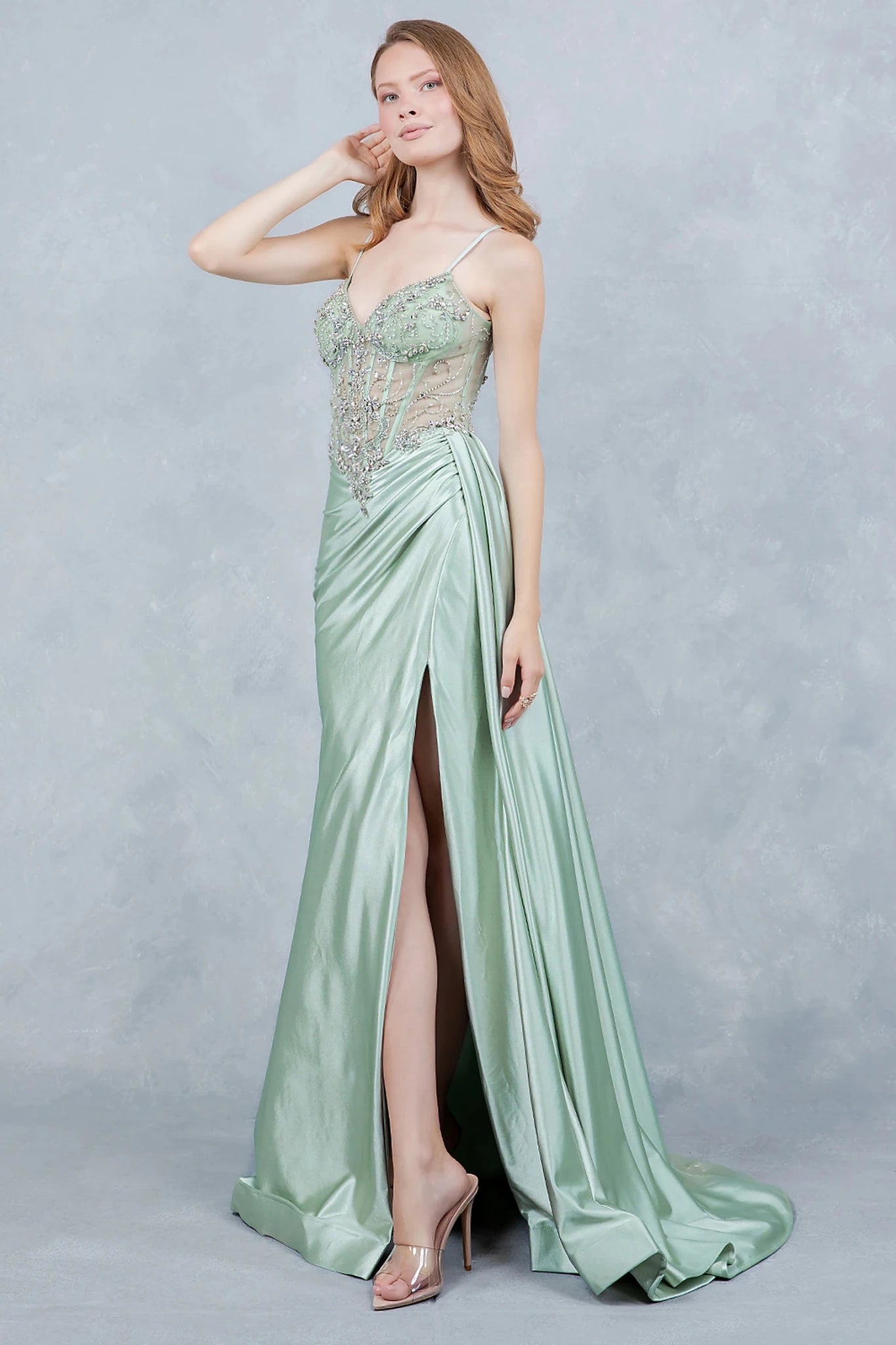 Sage prom dress styled with ruched satin skirt cascading into sleek silhouette