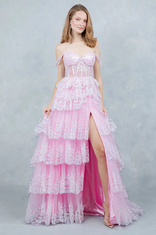Full front view of a women wearing pink glitter tulle prom dress with lace corset bodice.