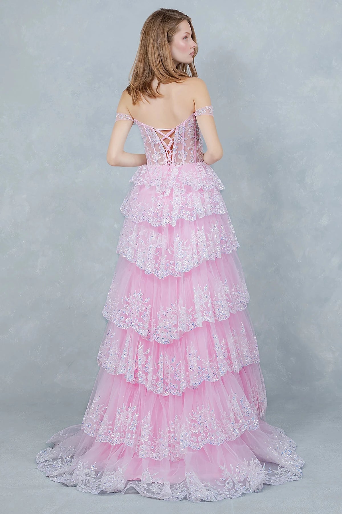 Pink prom dress featuring lace-up corset back with off-shoulder draped sleeves