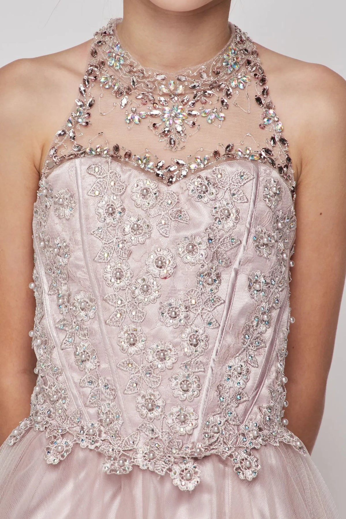 Finished details of a jeweled illusion halter neckline distinguish the Blush kids party dress.