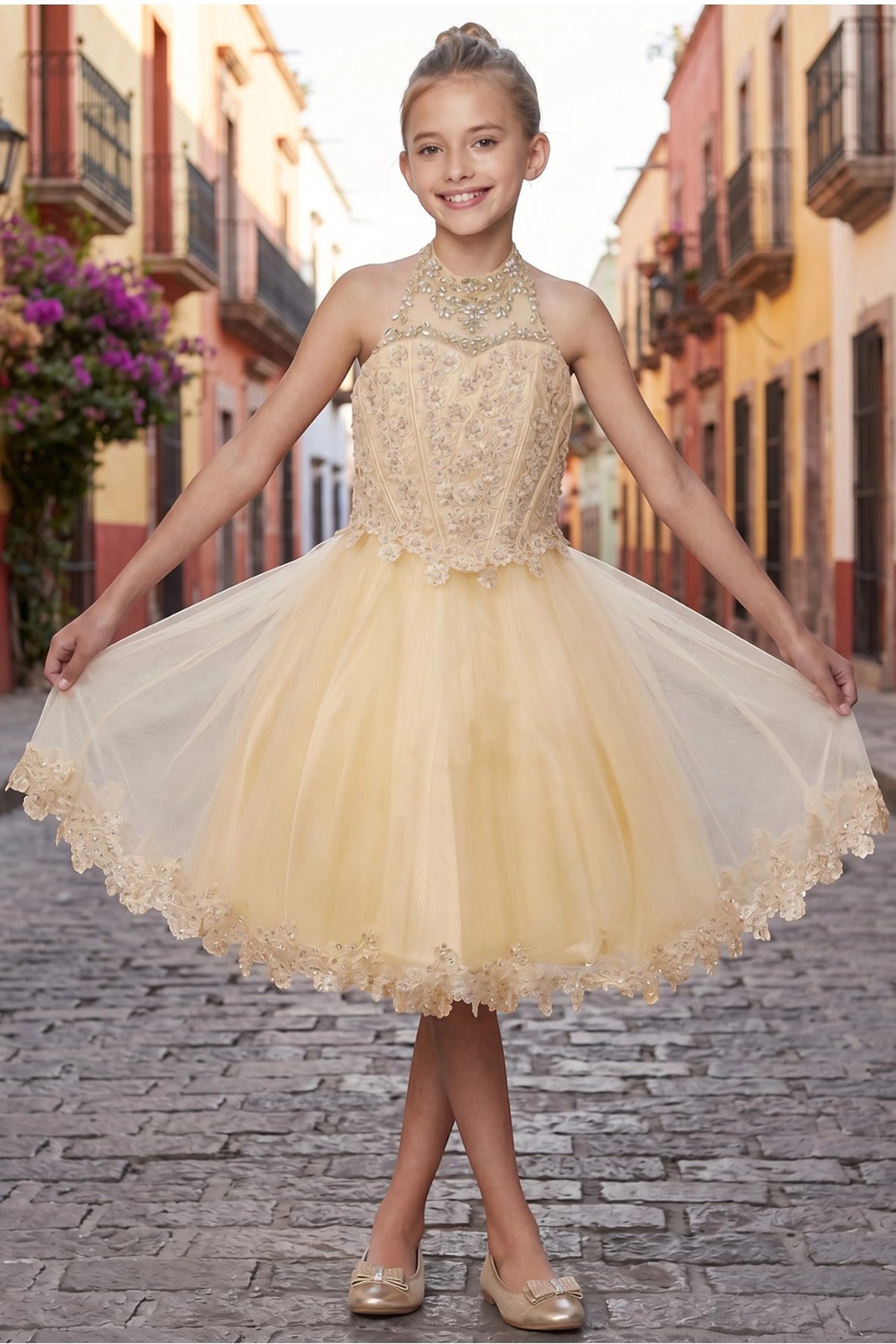 Showcasing with a jeweled illusion halter neckline, this Champagne kids party dress displays elegant detail.