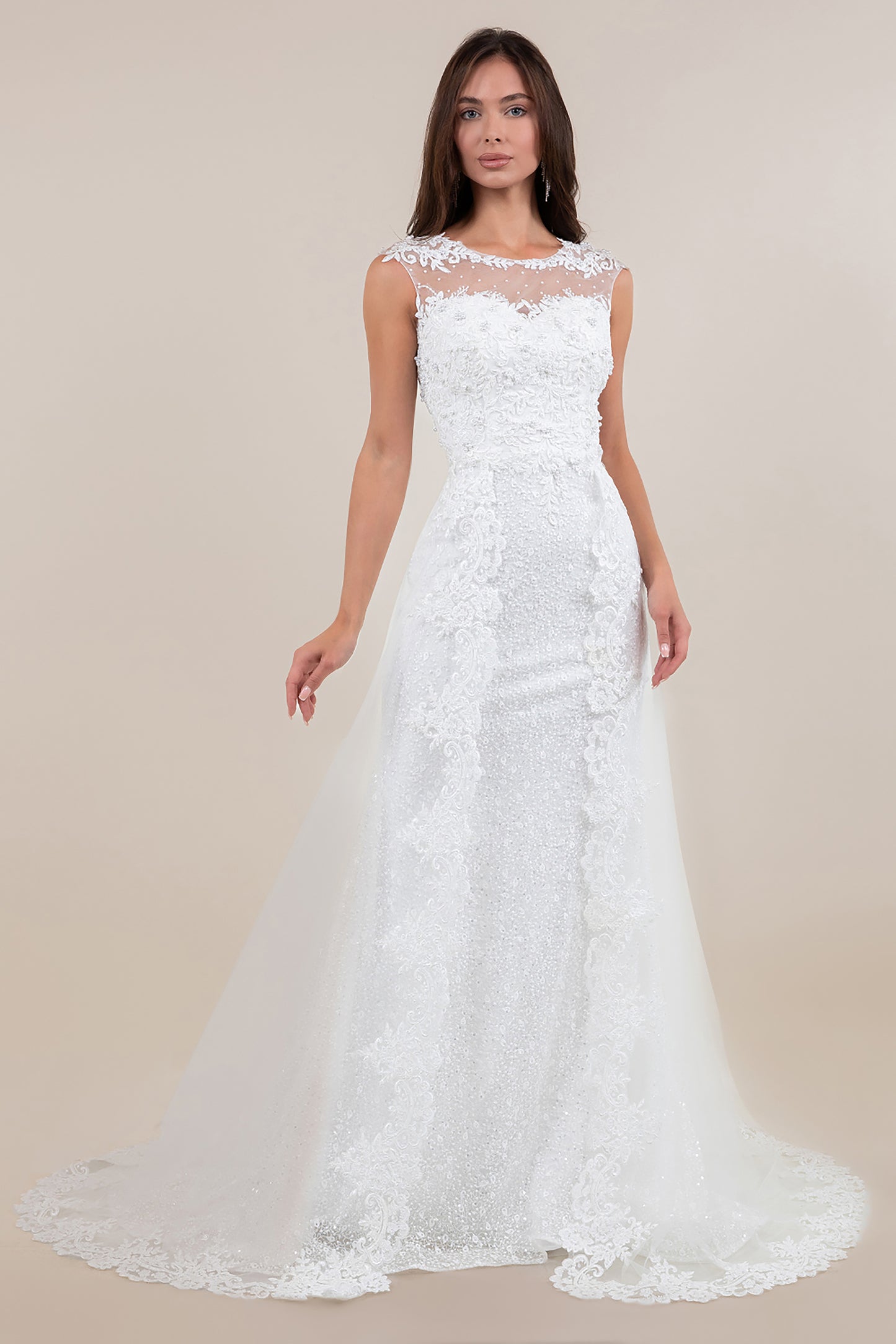 White lace wedding dress on a model against a beige background