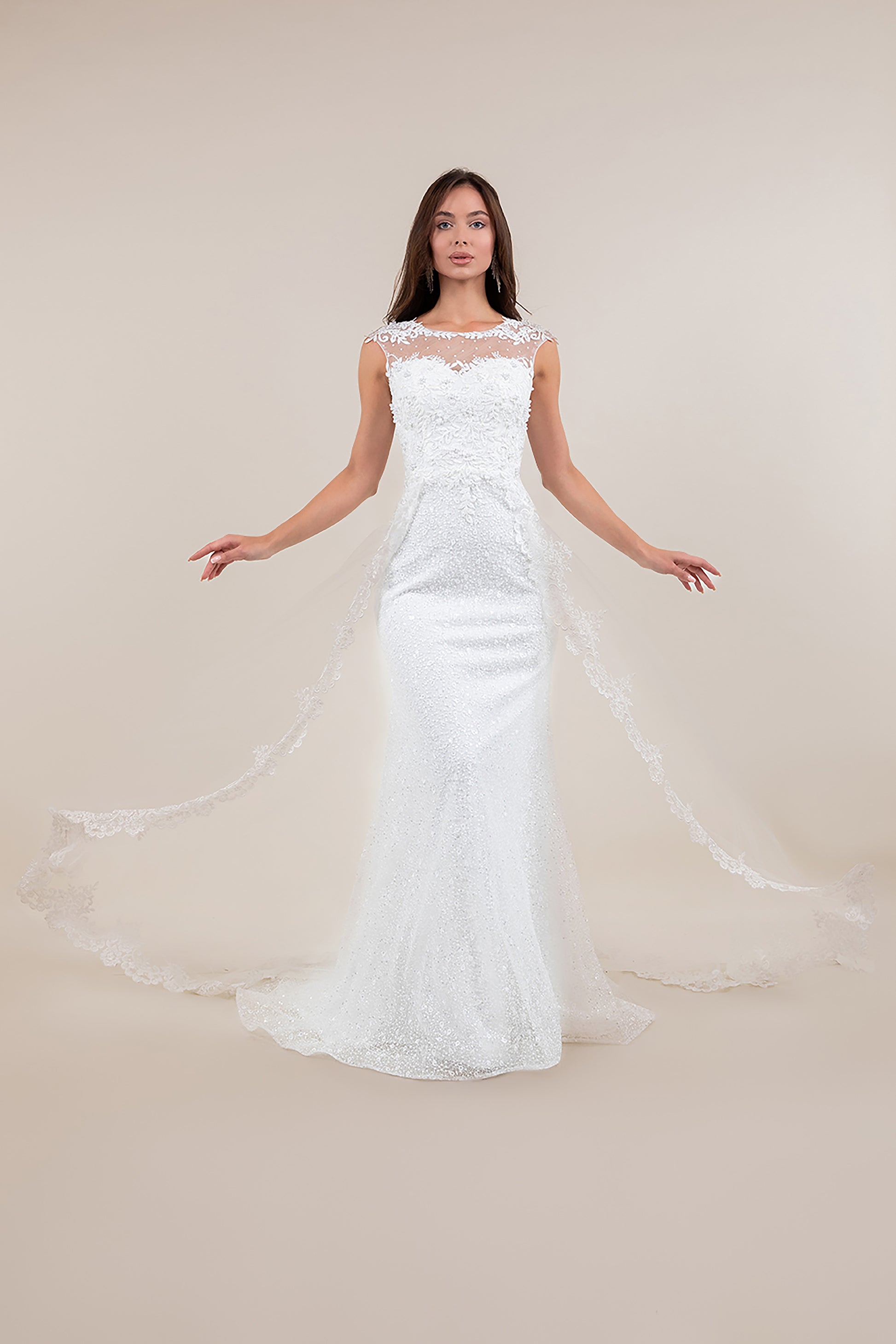 Woman wearing a white lace wedding dress on a plain background