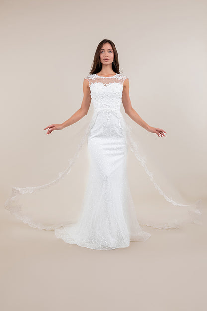 Woman wearing a white lace wedding dress on a plain background