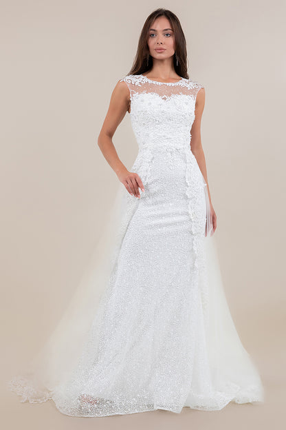 Woman wearing a white lace wedding dress against a beige background