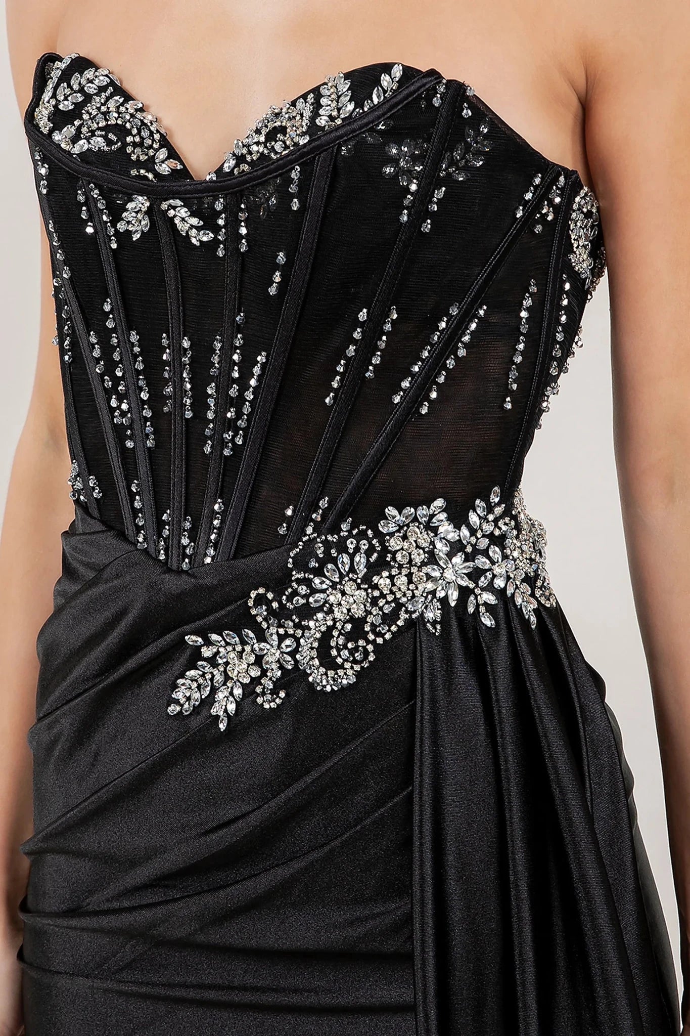 Black satin prom dress featuring crystal rhinestone beadwork in floral vine motif