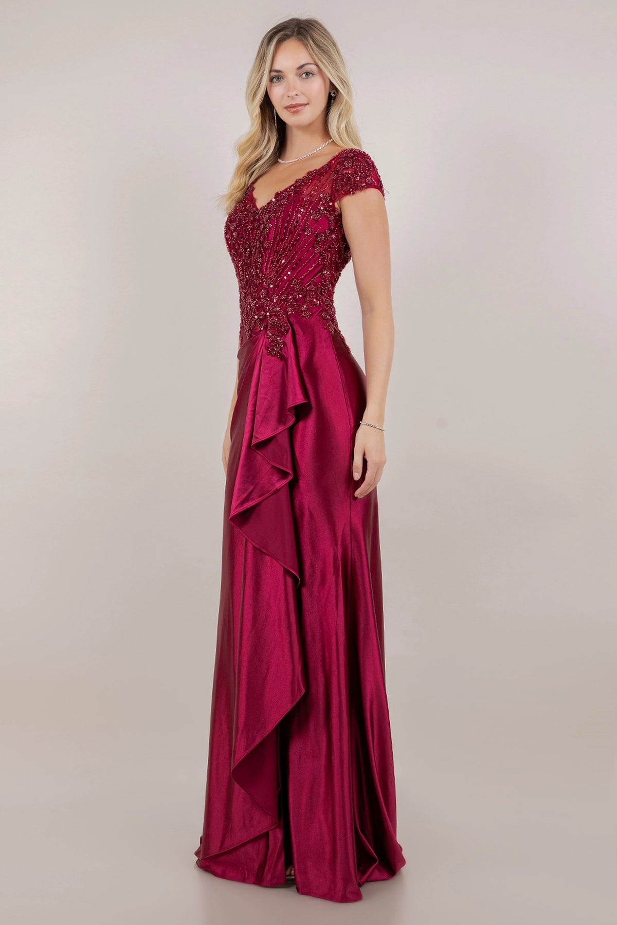 An angled Wine mother of the bride dress view highlights the front slit and glossy draped satin.