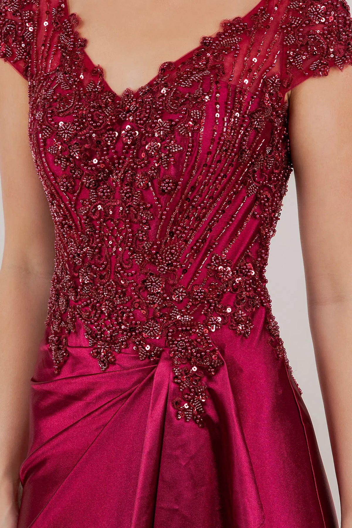 Sparkling hand-beaded lace shapes the cap-sleeve bodice on this Wine mother of the bride dress.
