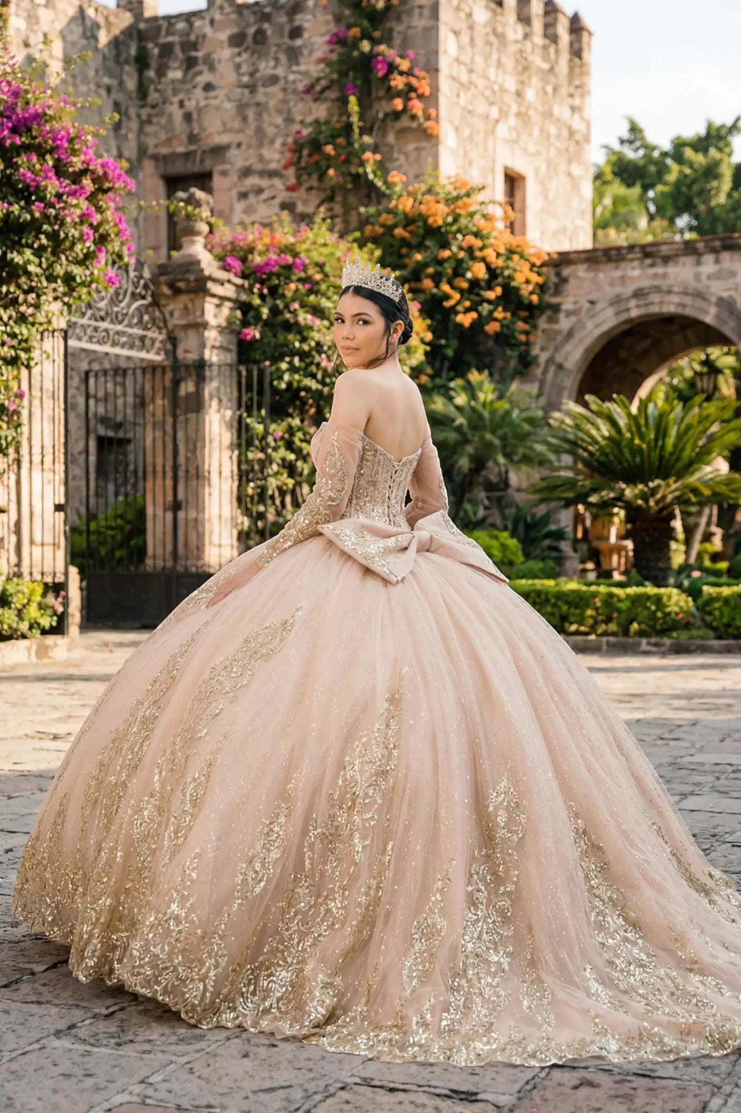 Back view of a woman wearing mocha quinceañera dress with voluminous layered skirt, lace-up corset closure, and gold embroidered accents.