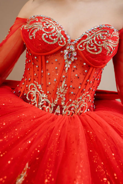 Bodice close-up of a woman wearing red quinceañera dress showing intricate gold embroidery, sequins, and beadwork details.