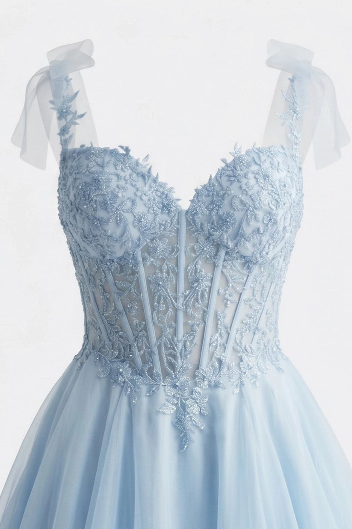 Detail of this Blue prom and evening dress shows floral lace and beadwork.