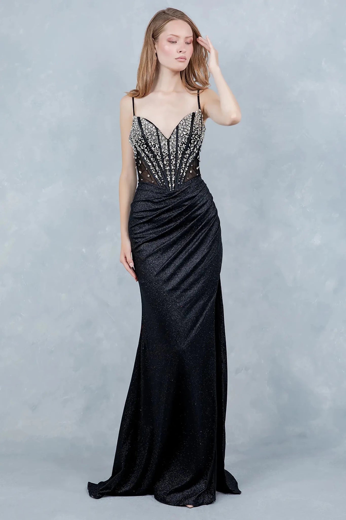 Full front view of a women wearing black glitter knit prom dress with V-neck crystal bodice.