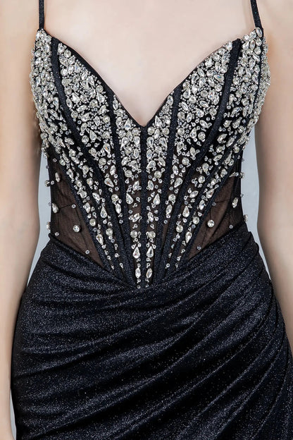A close-up view of a woman wearing a black crystal corset bodice with an illusion panel.