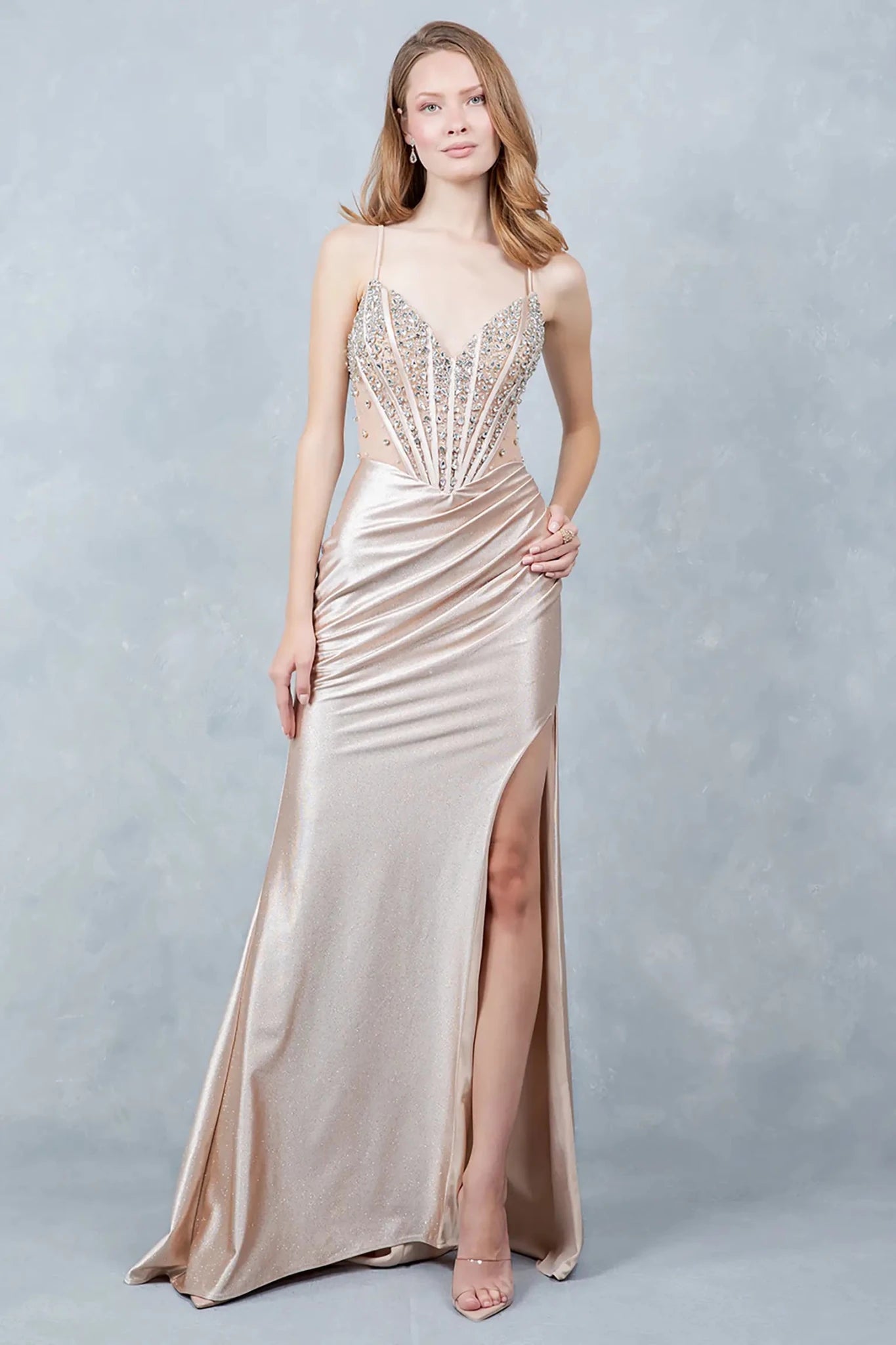 Full front view of a women wearing champagne glitter knit prom dress with crystal bodice.