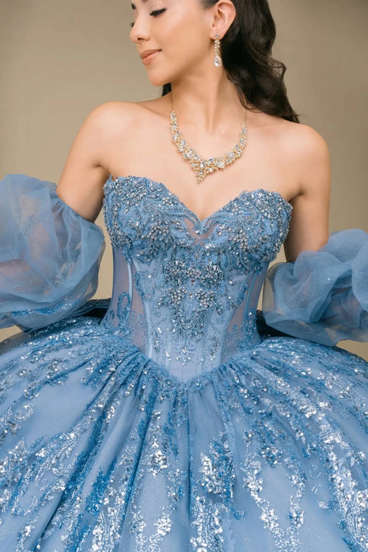 Close-up of woman wearing dusty blue off-shoulder sweetheart quinceañera dress with beaded sequin bodice, sweetheart neckline, and voluminous tulle sleeve detail