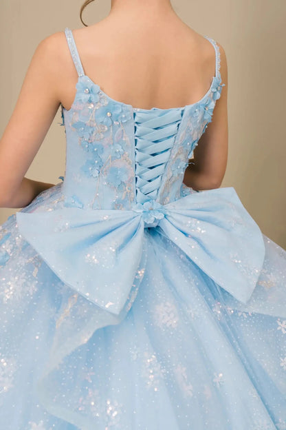 Close-up of mini quinceañera ball gown fabric with sequin floral embroidery and shimmering tulle layers