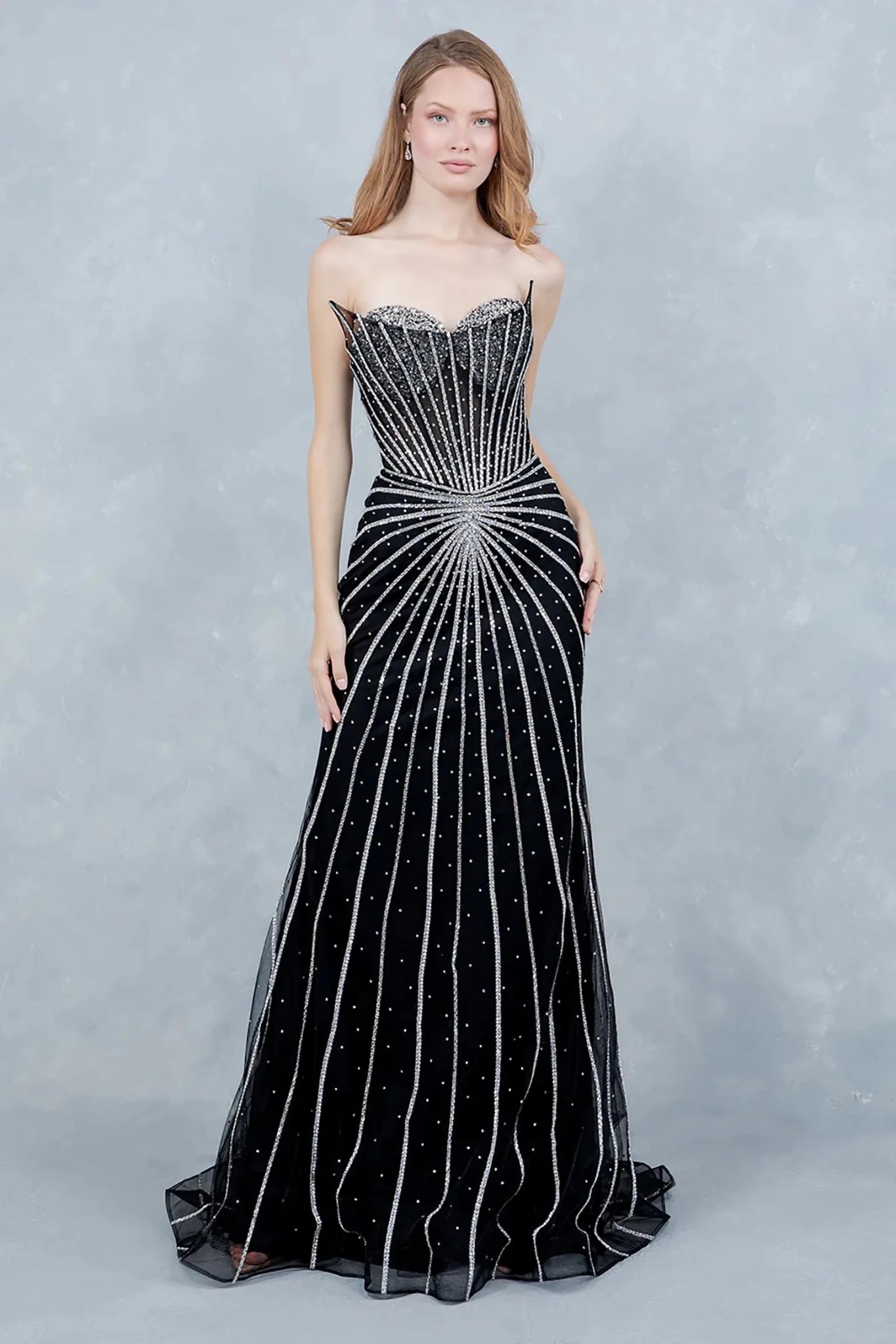 Full front view of a women wearing black crystal mermaid prom dress with strapless corset bodice.