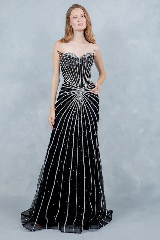 A full-length view of a woman wearing black mermaid prom dress with a lace-up corset detail.