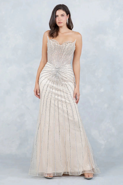 A full-length view of a woman wearing champagne mermaid dress with corset closure.