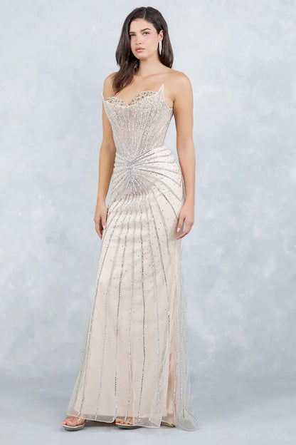 A side profile view of a woman wearing a champagne prom dress, highlighting the sculpted mermaid silhouette.