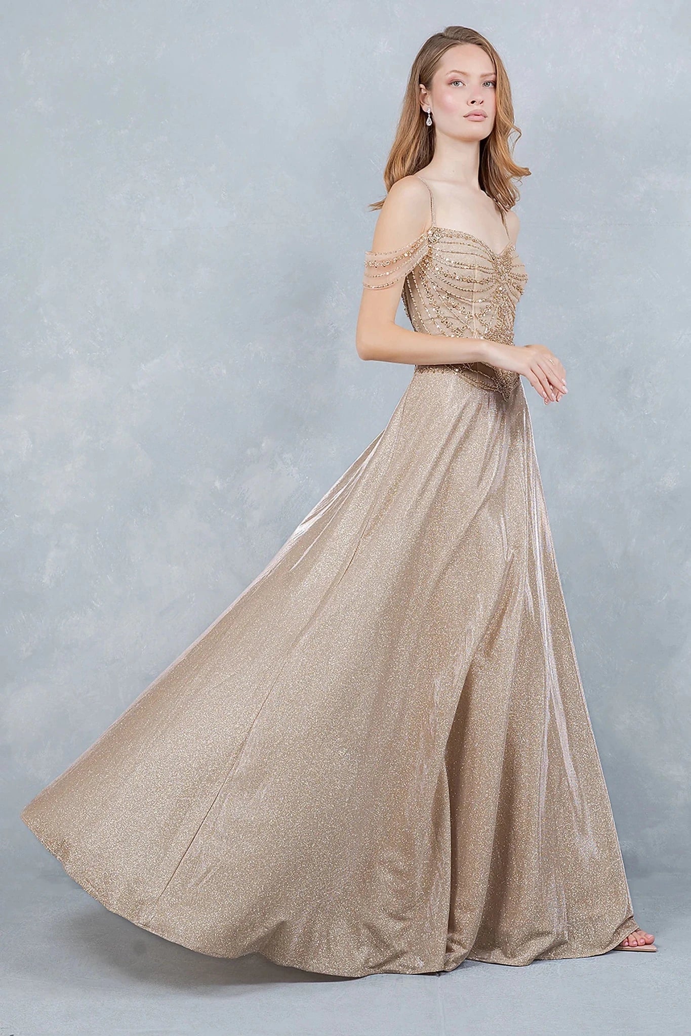 Champagne evening dress completed with floor-length finish for movement