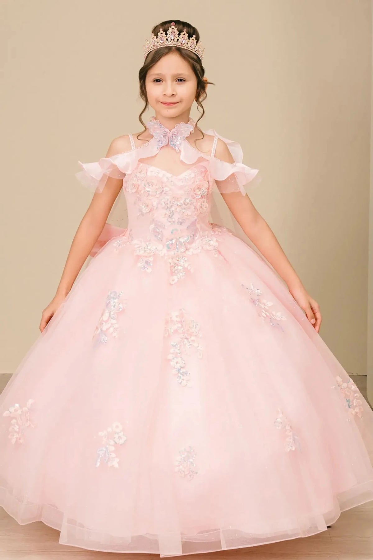 Bodice close-up highlights pink mini quinceañera mini quince dress with shimmering tulle skirt, off-shoulder ruffled sleeves.
