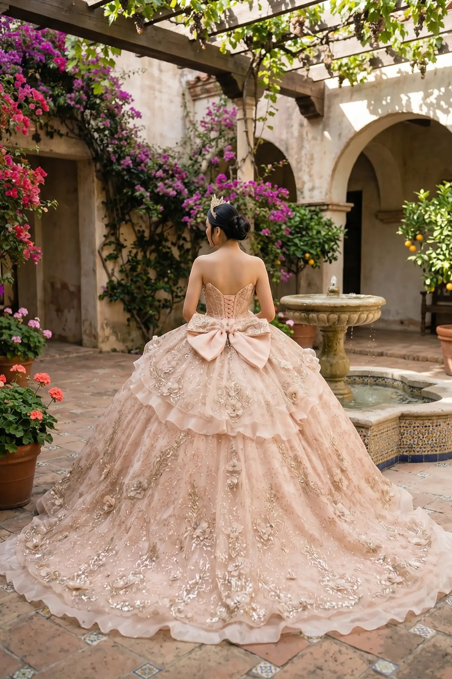 Back view of a woman wearing rose gold quinceañera dress with voluminous glitter tulle skirt, lace-up corset closure, and floral applique accents.