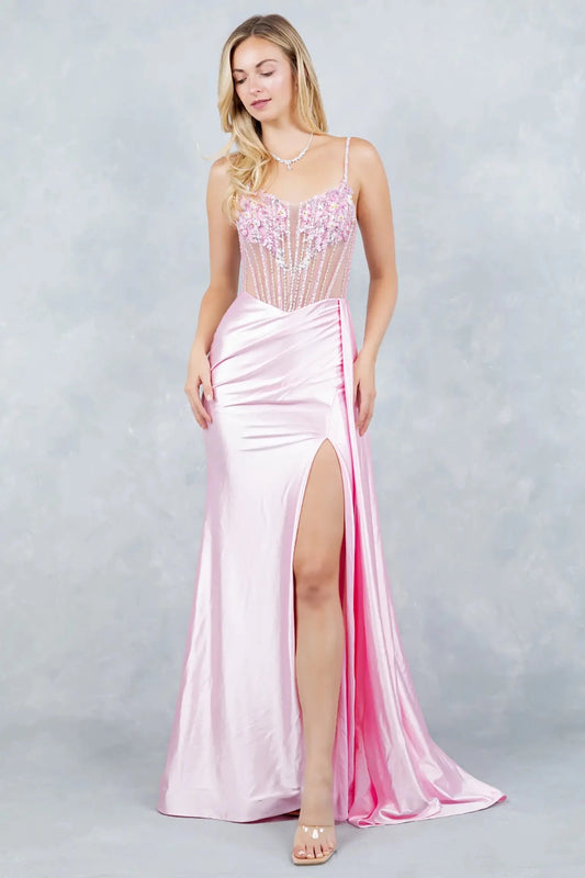 A full-length view of a woman wearing pink satin dress finished with a lace-up corset closure.