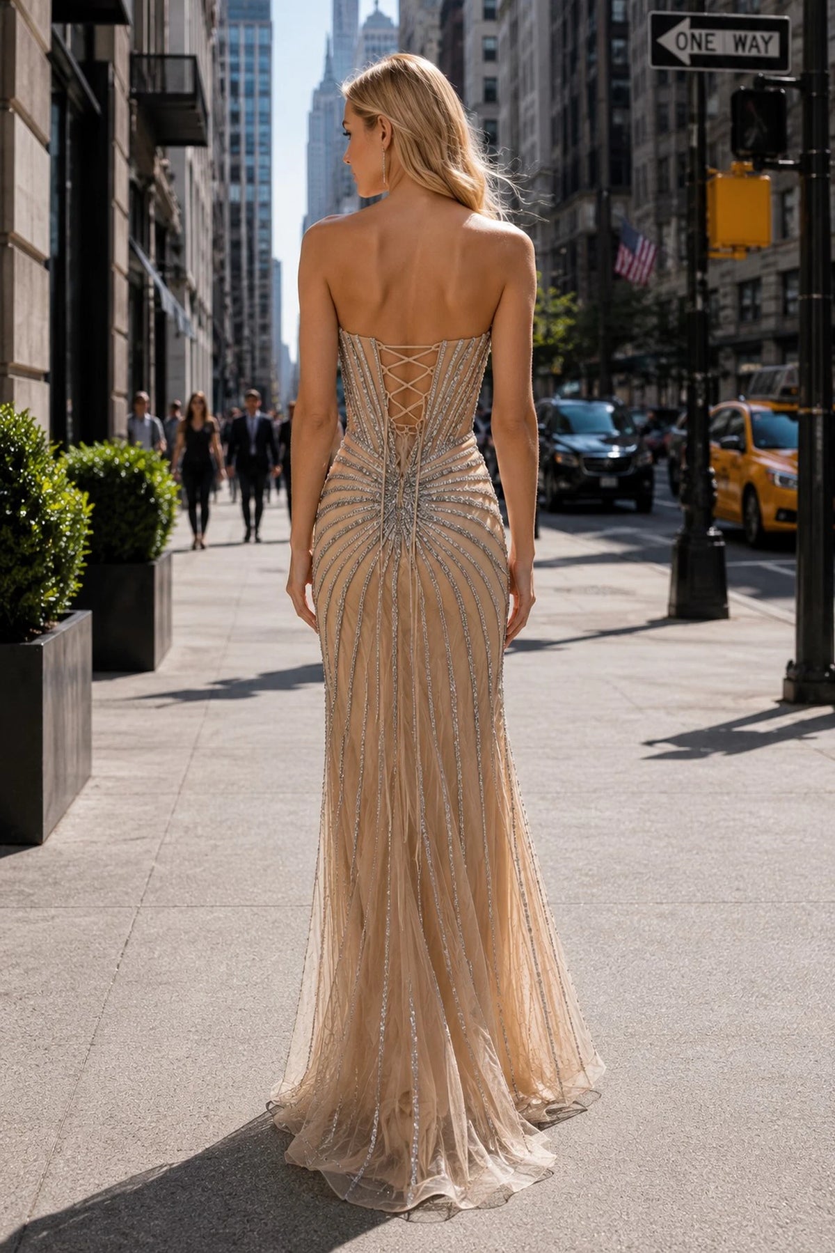 Back view of this Champagne prom and evening dress highlights the fitted back and flowing hem.
